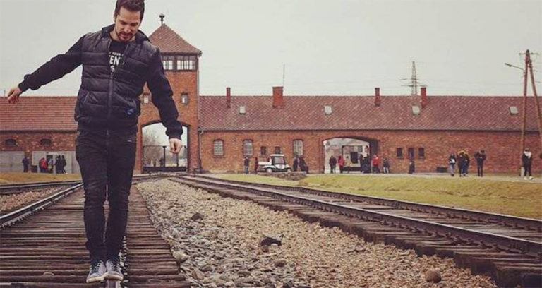 Man Balances On Auschwitz Tracks Featured