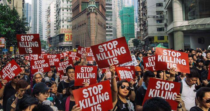 Protestors With Stop Killing Us Signs