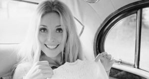 Sharon Tate Holds Baby Dress