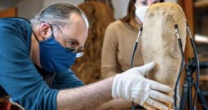 Man Examining Ibis Mummy