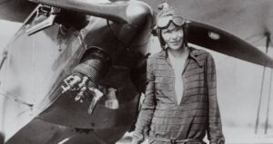 Amelia Earhart In Front Of Plane